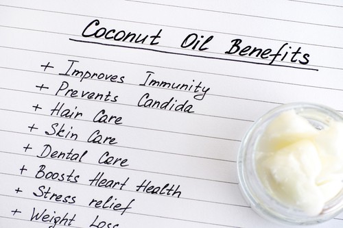 list of coconut oil benefits with jar of coconut oil on the side